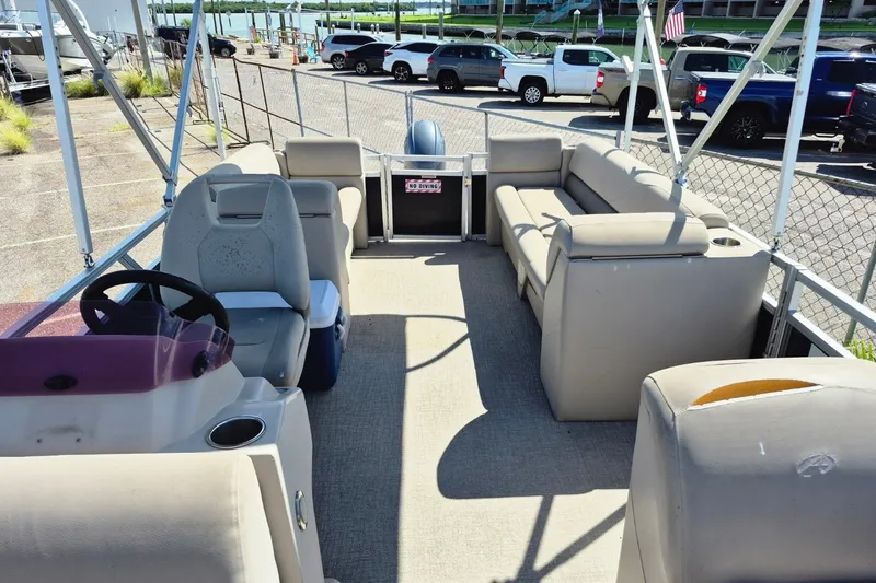 Slide: The Image of 2021 Avalon VLS 2080 QL pontoon boat interior with beige seating and steering console. - 22