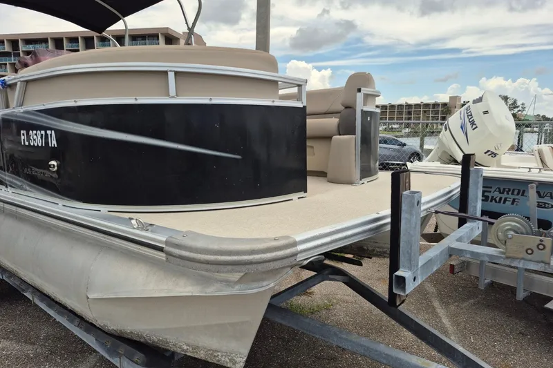 Slide: The Image of Pontoon boat Avalon VLS 2080 QL 2021 on trailer, docked with Suzuki outboard motor. - 6