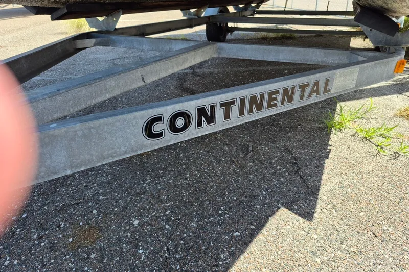 Slide: The Image of Continental boat trailer on pavement, partial view of Avalon VLS 2080 QL, 2021 model. - 28