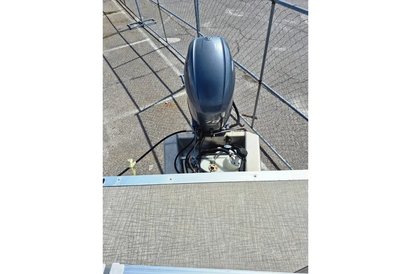 Slide: The Image of Outboard motor on Avalon VLS 2080 QL boat, 2021 model, parked on pavement. - 26
