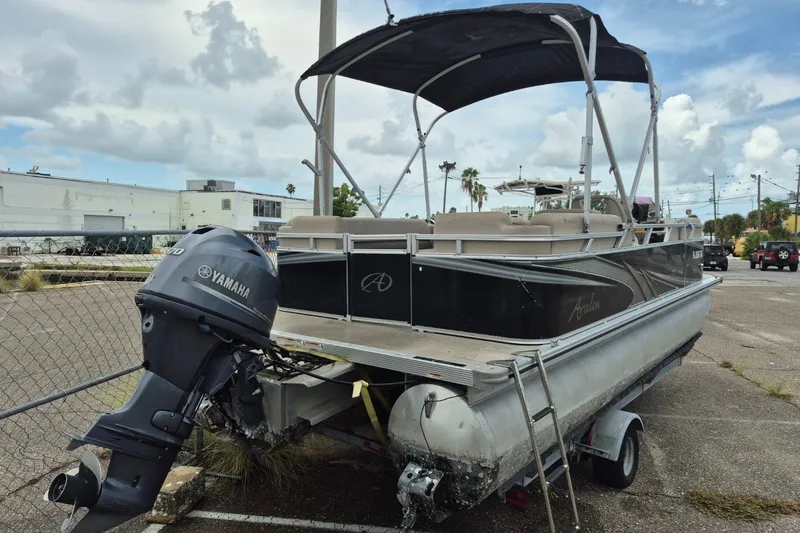 The Image of 2021 Avalon VLS 2080 QL pontoon boat with Yamaha outboard motor in a parking lot. - 0