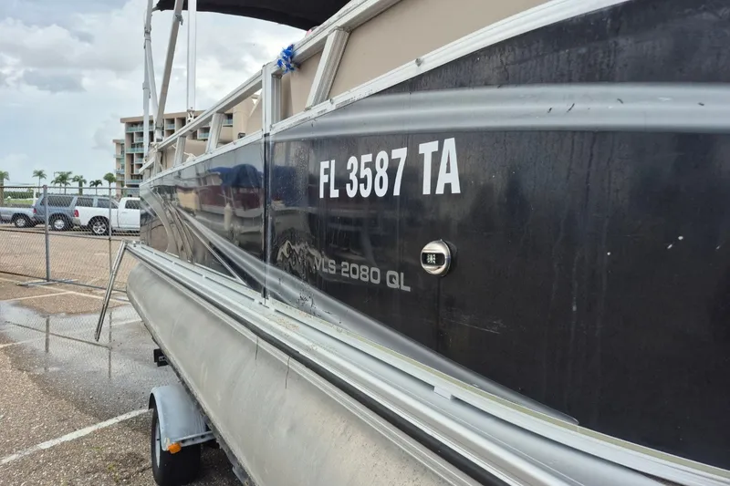 Slide: The Image of 2021 Avalon VLS 2080 QL pontoon boat parked, displaying registration FL 3587 TA. - 2