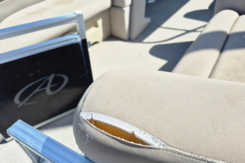 Slide: The Image of Torn upholstery on Avalon VLS 2080 QL boat seat, 2021 model, with visible interior padding. - 24