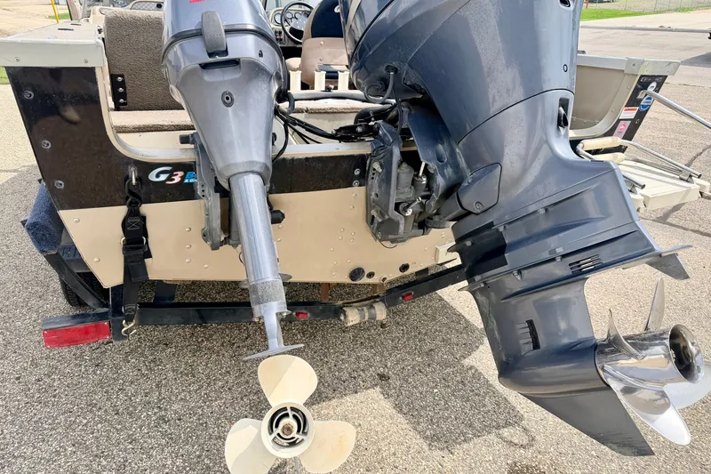 Slide: The Image of 2008 G3 Angler V185 FS boat with dual outboard motors on a trailer. - 21