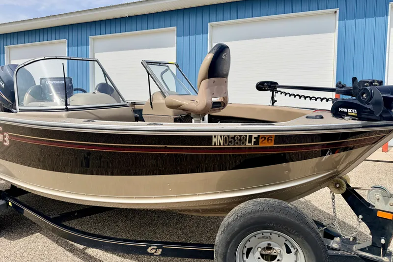 Slide: The Image of 2008 G3 Angler V185 FS boat on trailer, parked near blue building. - 24