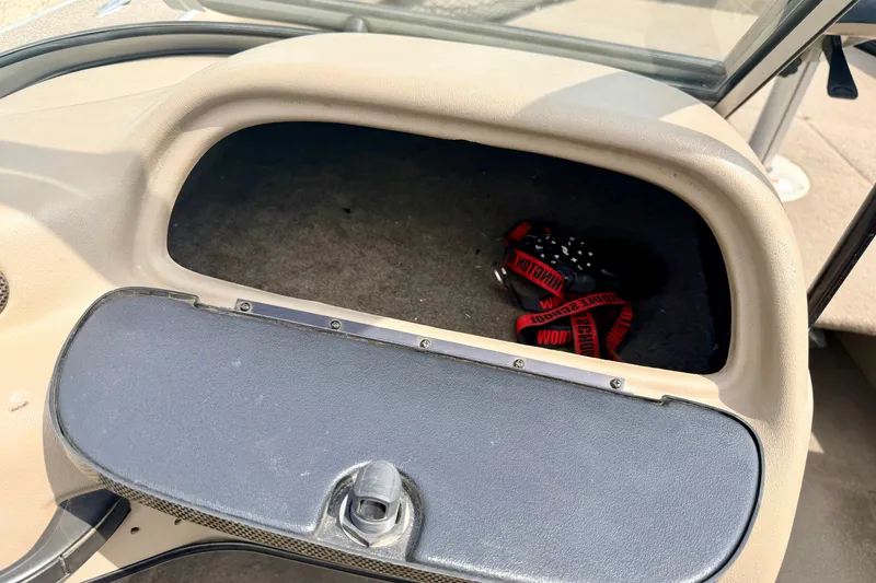 Slide: The Image of Open glove compartment in 2008 G3 Angler V185 FS boat with red strap inside. - 47