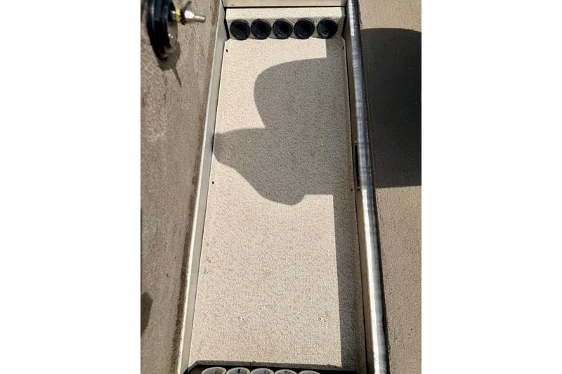Slide: The Image of 2008 G3 Angler V185 FS boat interior with rod holders and carpeted flooring. - 50
