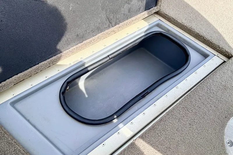 Slide: The Image of Storage compartment in 2008 G3 Angler V185 FS boat, featuring a secure, carpeted design. - 54