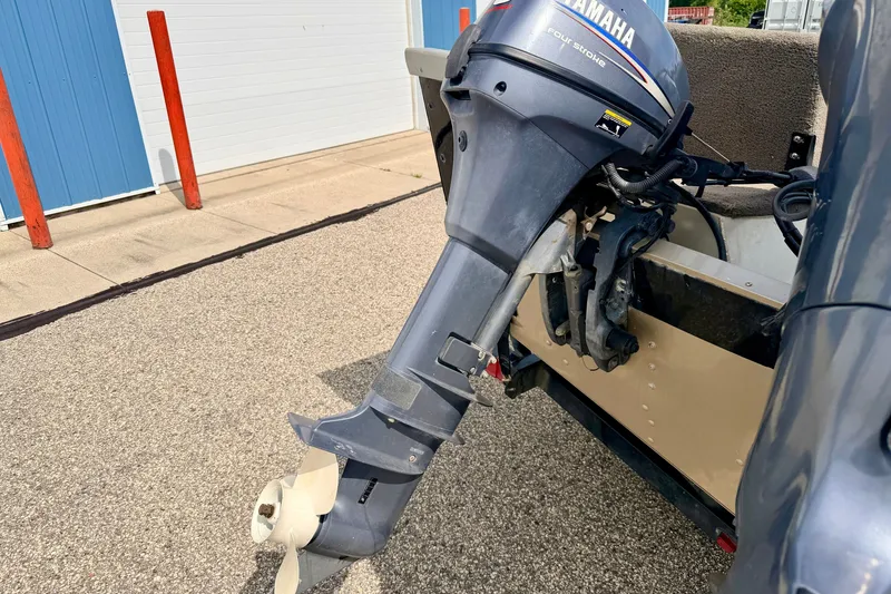 Slide: The Image of 2008 G3 Angler V185 FS with Yamaha four-stroke outboard motor, parked on pavement. - 18