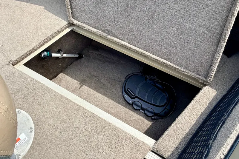Slide: The Image of Storage compartment in 2008 G3 Angler V185 FS boat, featuring fishing rod and equipment. - 56