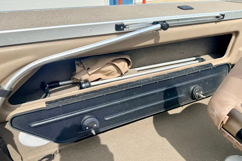Slide: The Image of Storage compartment in a 2008 G3 Angler V185 FS boat, featuring beige interior and equipment. - 37