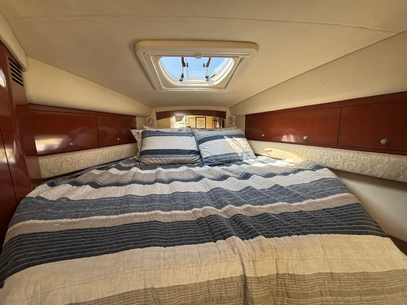 Slide: The Image of Cabin of the 2005 Sea Ray 340 Sundancer with a cozy bed and skylight. - 15