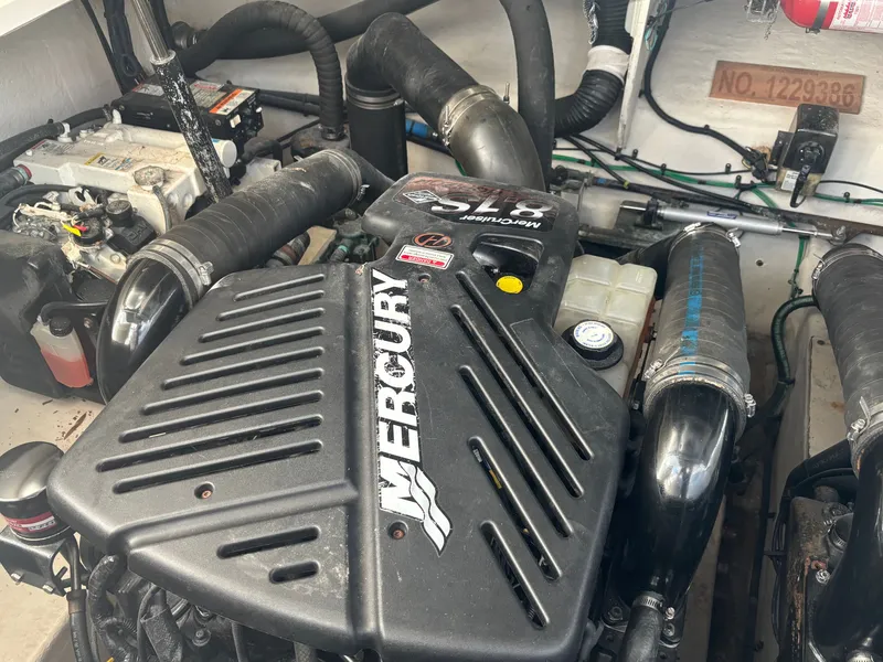 Slide: The Image of Engine room of a 2005 Sea Ray 340 Sundancer with a Mercury engine and various hoses. - 19