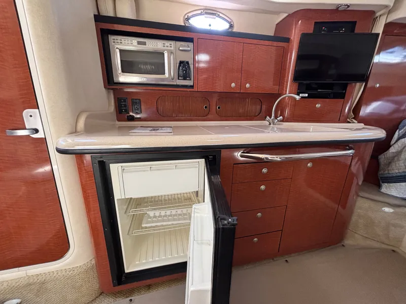 Slide: The Image of The galley of a 2005 Sea Ray 340 Sundancer with microwave, refrigerator, and sink. - 14