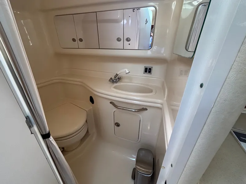 Slide: The Image of The image shows the bathroom of a 2005 Sea Ray 340 Sundancer with a sink and toilet. - 17