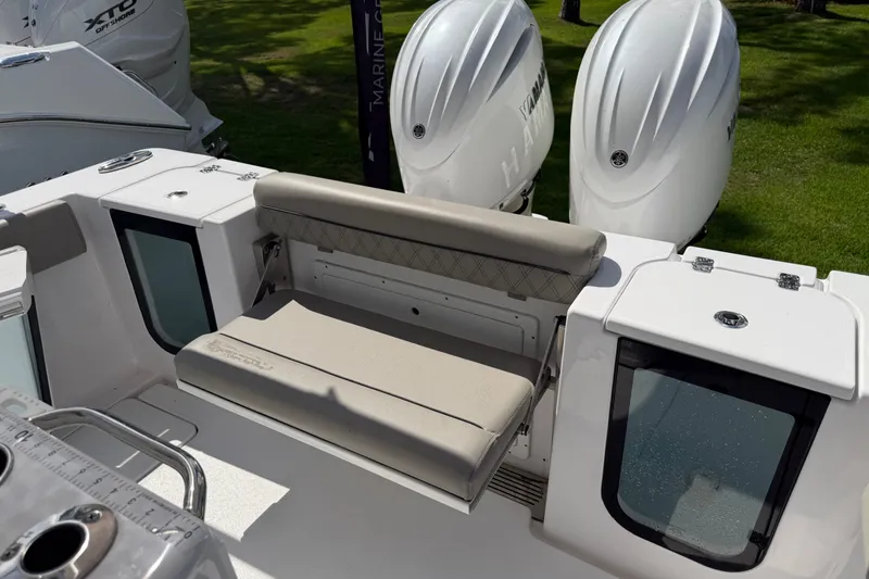 Slide: The Image of 2025 Sportsman Open 262 Center Console boat with dual outboard engines and seating. - 28