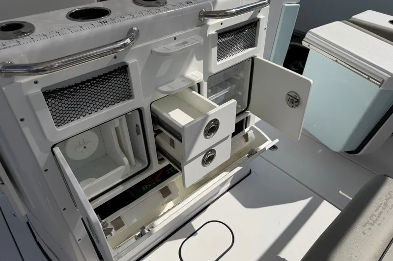 Slide: The Image of 2025 Sportsman Open 262 Center Console storage compartments with open drawers and doors. - 30