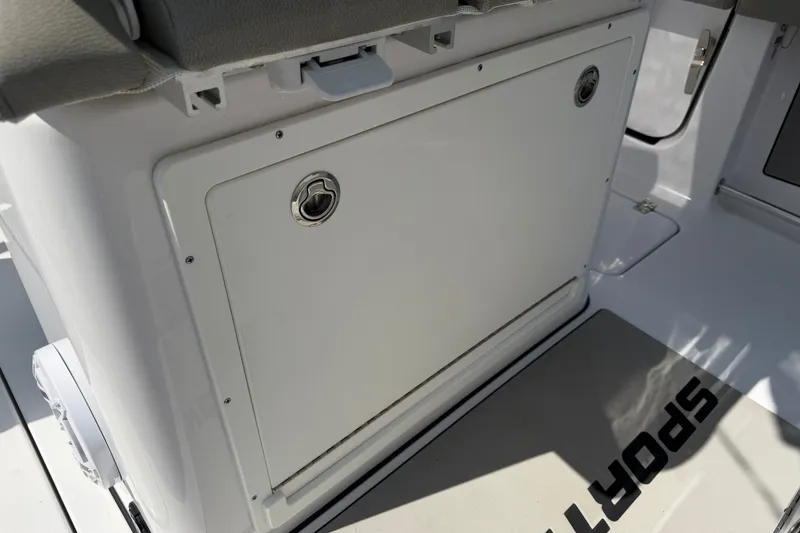 Slide: The Image of 2025 Sportsman Open 262 Center Console storage compartment with secure latch. - 20