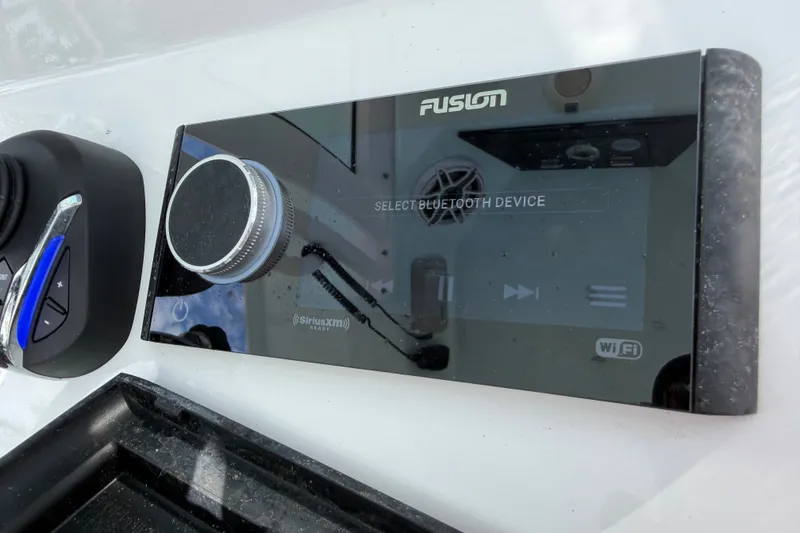 Slide: The Image of Fusion audio control panel on 2025 Sportsman Open 262 Center Console boat. - 17