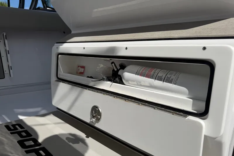 Slide: The Image of Storage compartment in 2025 Sportsman Open 262 Center Console boat with fire extinguisher. - 19