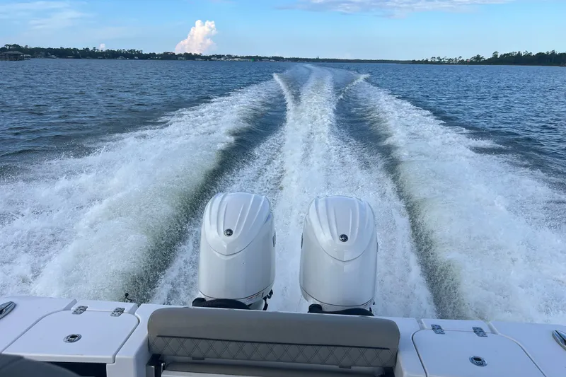 Slide: The Image of 2025 Sportsman Open 262 Center Console boat cruising on open water, leaving a wake. - 34