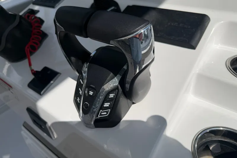 Slide: The Image of Throttle control on 2025 Sportsman Open 262 Center Console boat dashboard. - 13