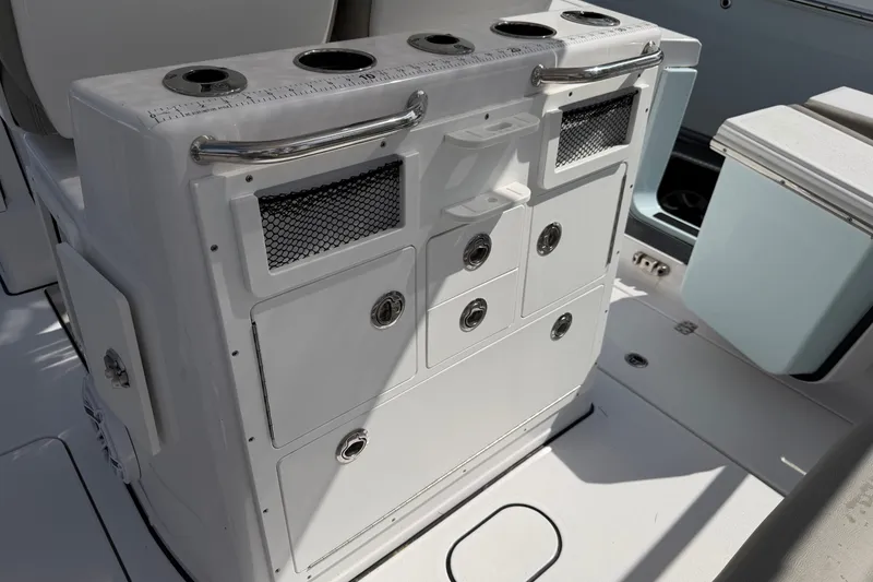 Slide: The Image of 2025 Sportsman Open 262 Center Console boat interior with storage compartments and cup holders. - 29