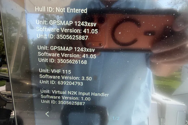 Slide: The Image of Display screen showing software versions and unit IDs for GPSMAP and VHF on Sportsman Open 262. - 22