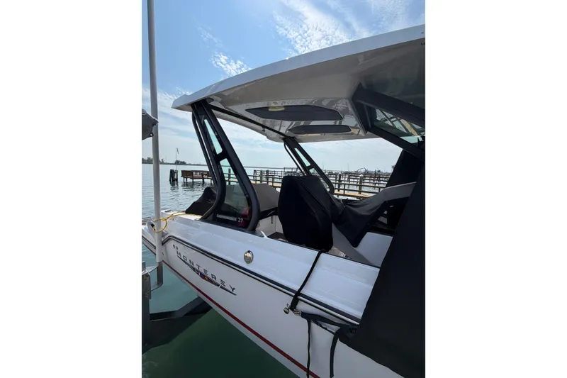 Slide: The Image of 2026 Monterey Elite 27 SD boat docked by the water, showcasing sleek design. - 20
