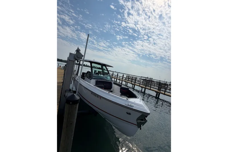 The Image of 2026 Monterey Elite 27 SD boat docked under a partly cloudy sky. - 1