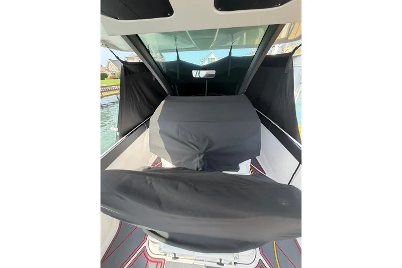 Slide: The Image of 2026 Monterey Elite 27 SD boat interior with protective covers, docked by the water. - 18