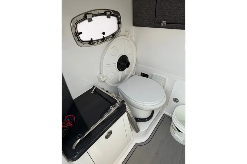 Slide: The Image of 2026 Monterey Elite 27 SD boat interior with compact bathroom and modern amenities. - 14