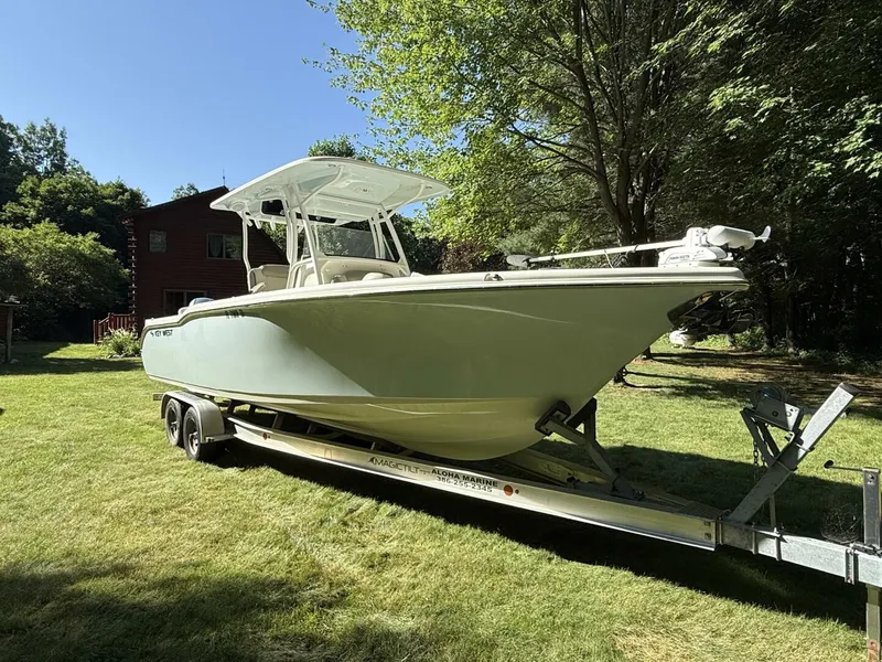 The Image of A 2023 Key West 263 FS boat on a trailer in a grassy area. - 1