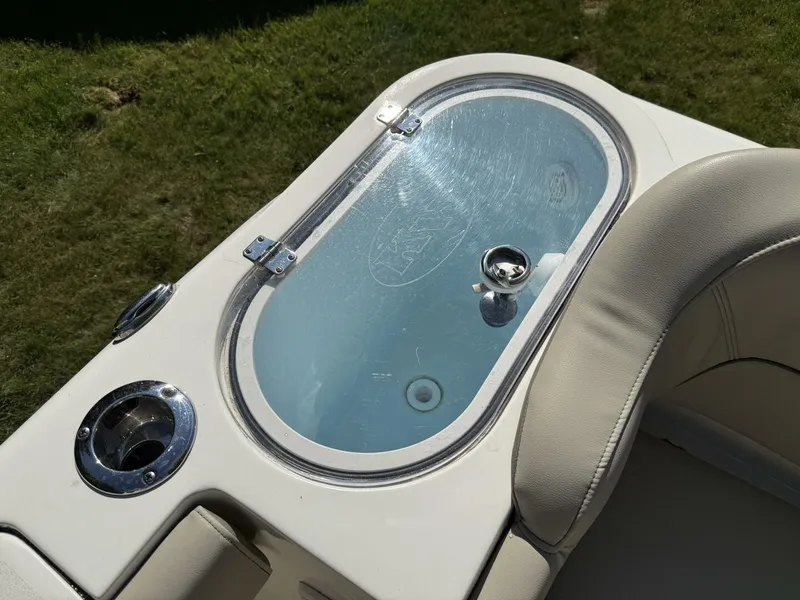 Slide: The Image of A sleek, oval glass-top table with cushioned seating on a Key West 263 FS boat. - 14