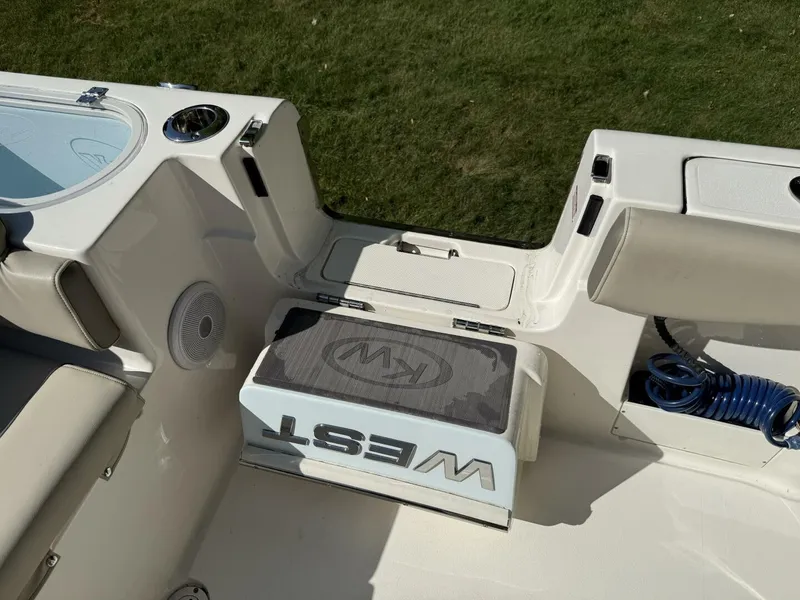 Slide: The Image of The image shows the cockpit of a 2023 Key West 263 FS boat with seating and storage. - 20