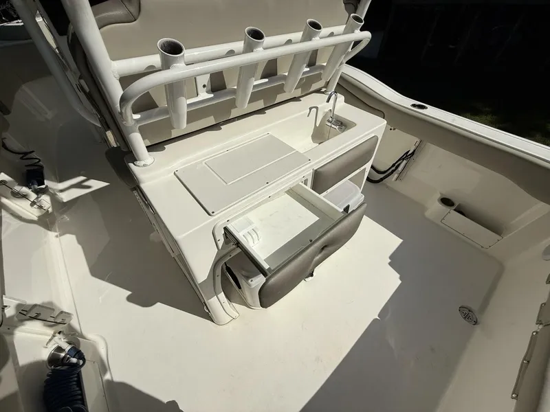 Slide: The Image of The image shows the cockpit of a Key West 263 FS boat with storage and fishing rod holders. - 18