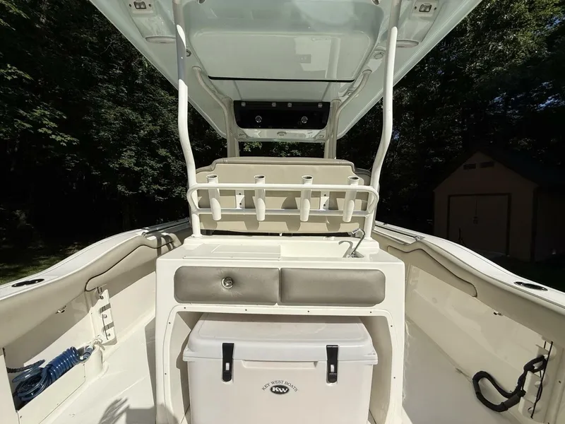 Slide: The Image of The image shows the cockpit of a 2023 Key West 263 FS boat with storage and seating. - 16