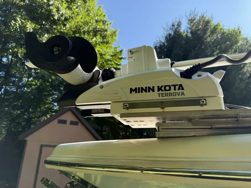 Slide: The Image of A Minn Kota Terrova motor is mounted on a boat, surrounded by trees and a shed. - 35