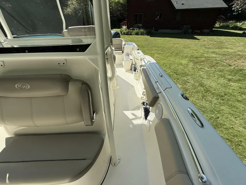 Slide: The Image of The image shows the deck of a 2023 Key West 263 FS boat with gray seating. - 34