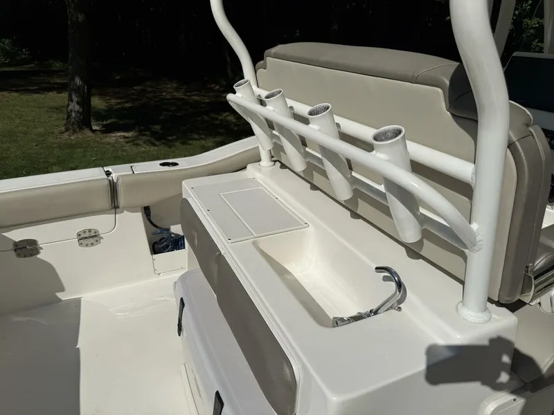 Slide: The Image of The image shows the cockpit of a 2023 Key West 263 FS boat with fishing rod holders. - 19