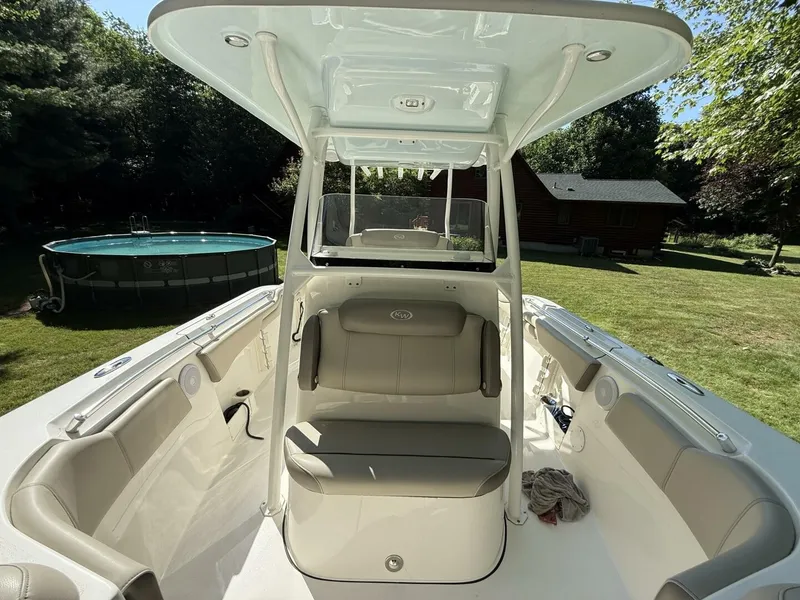 Slide: The Image of The image shows the cockpit of a 2023 Key West 263 FS boat with beige seating. - 32