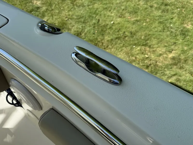 Slide: The Image of Close-up of a boat deck featuring a shiny metal cleat and a speaker. - 39