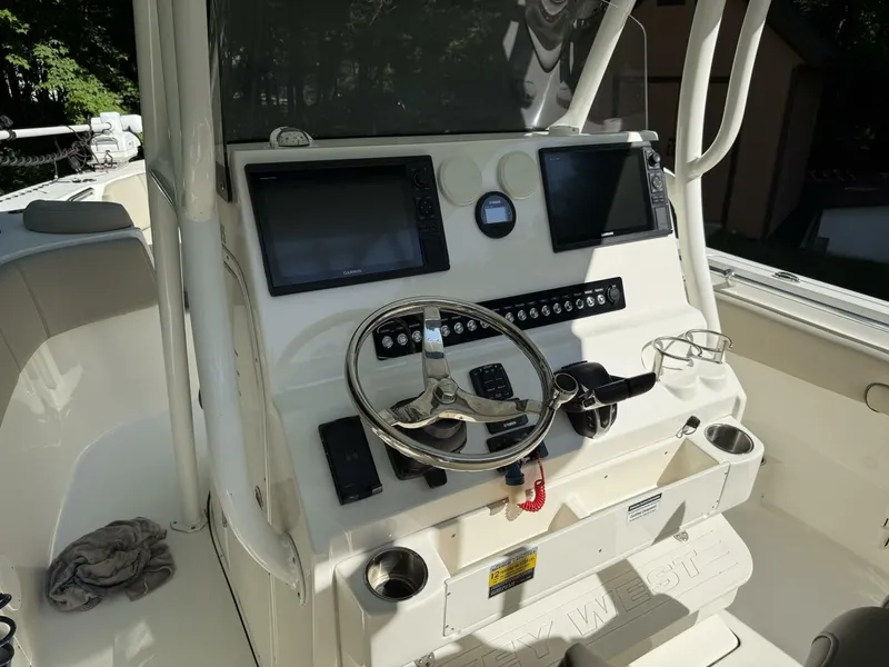 Slide: The Image of 2023 Key West 263 FS helm with dual screens and stainless steel steering wheel. - 21