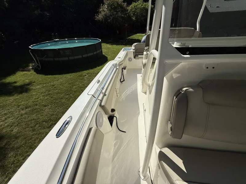 Slide: The Image of The image shows the deck of a 2023 Key West 263 FS boat, positioned on a lawn. - 33