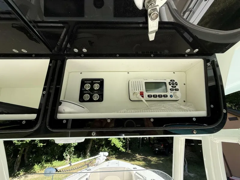 Slide: The Image of The image shows the dashboard of a Key West 263 FS boat with a radio and switches. - 28