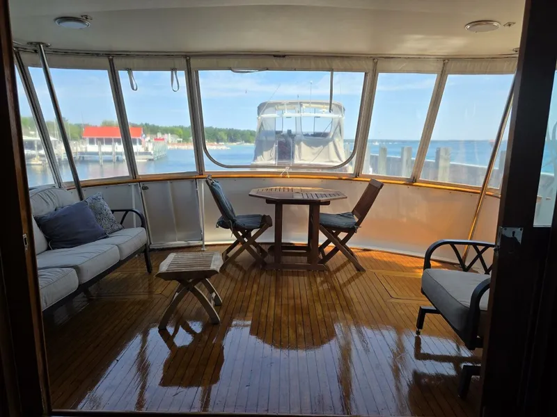 Slide: The Image of Interior of a 1976 Chris-Craft Roamer 60 with wooden floor, table, and chairs. - 35