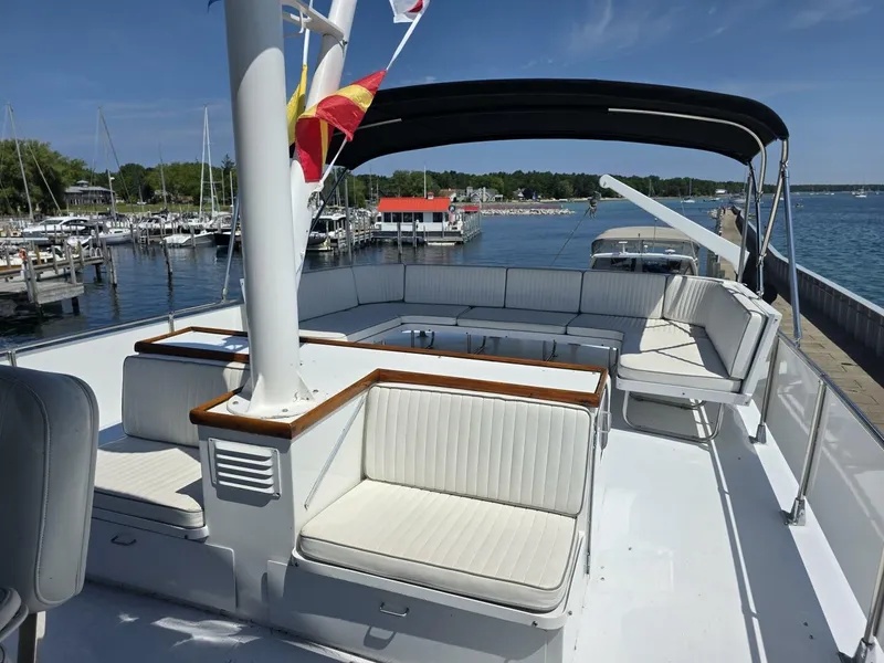 Slide: The Image of The image shows the deck of a 1976 Chris-Craft Roamer 60 with white seating. - 19