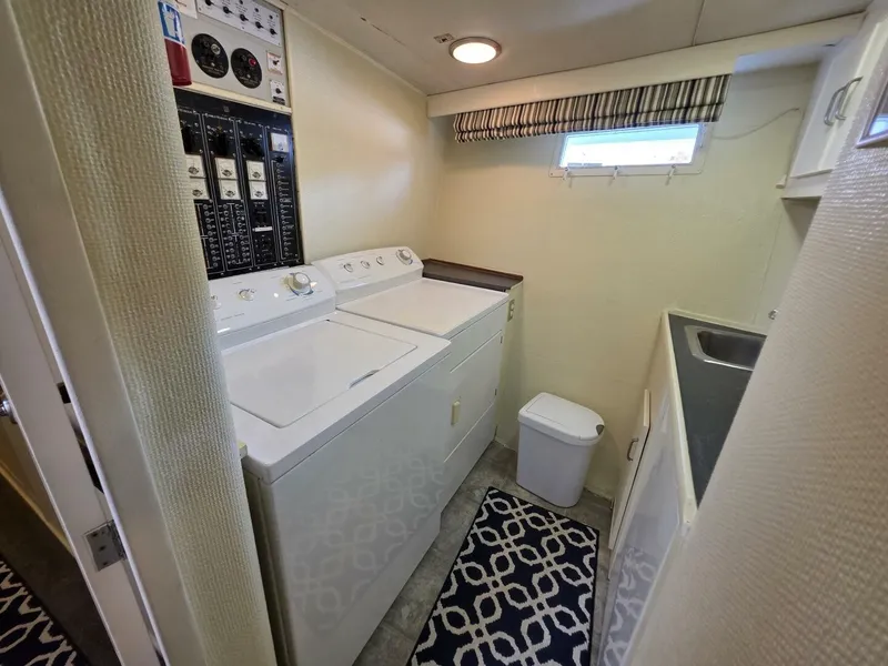 Slide: The Image of Interior of a 1976 Chris-Craft Roamer 60 with a washer, dryer, and sink. - 43