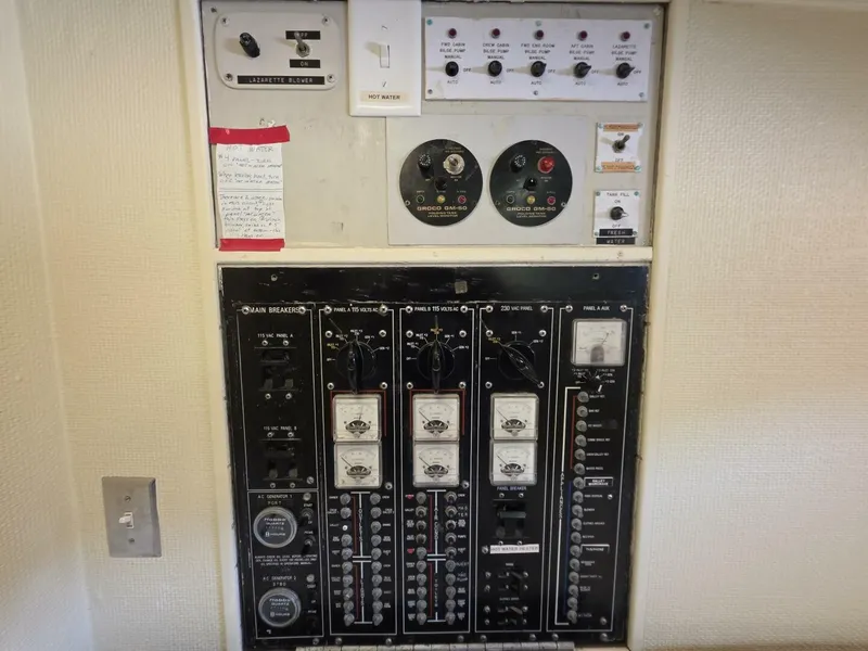 Slide: The Image of Electrical control panel with various switches and gauges on a 1976 Chris-Craft Roamer 60. - 45