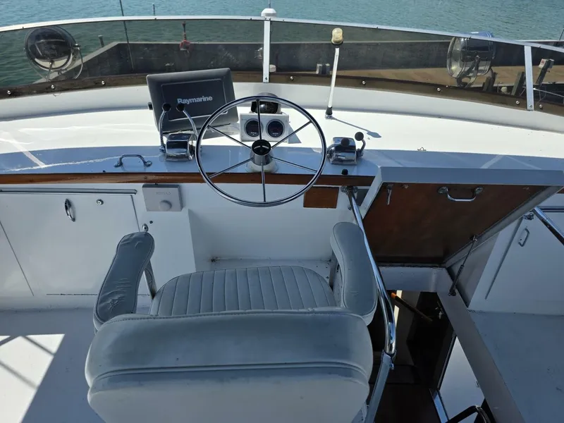 Slide: The Image of The image shows the helm of a 1976 Chris-Craft Roamer 60 with a steering wheel and navigation equipment. - 18